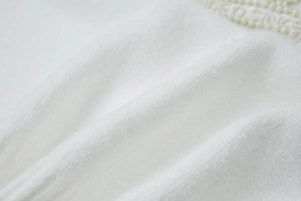 Embroidered pearl micro label round neck sweater
