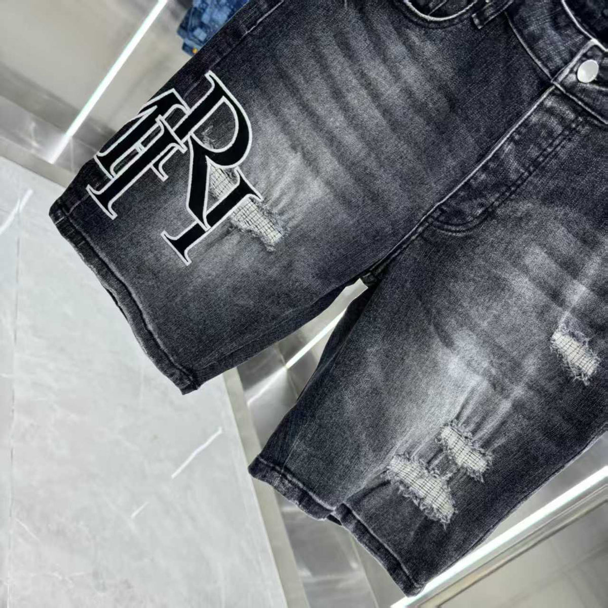 Ripped letter embroidered jeans