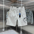 Embroidered cross denim shorts with torn holes
